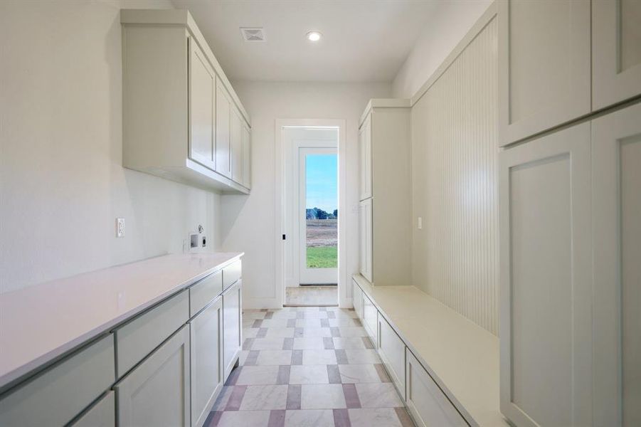 Laundry area featuring cabinets and electric dryer hookup