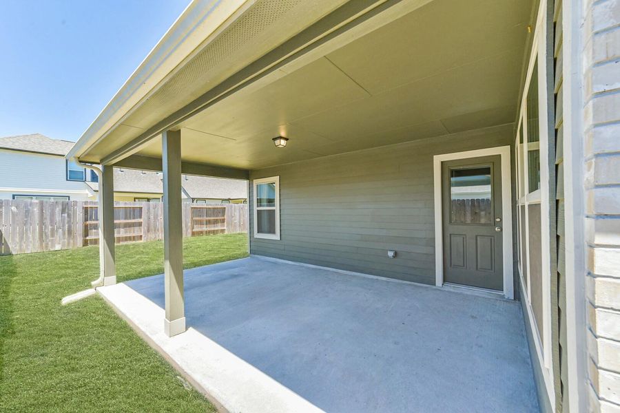 An alternate view of the covered patio highlights the generous space and easy access back into the home, perfect for indoor and outdoor living. An alternate view of the covered patio highlights the generous space and easy access back into the home, perfect for indoor and outdoor living.