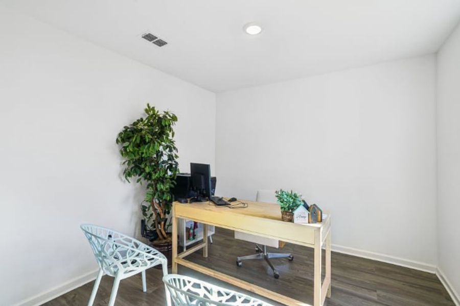 A room with a desk and chair.