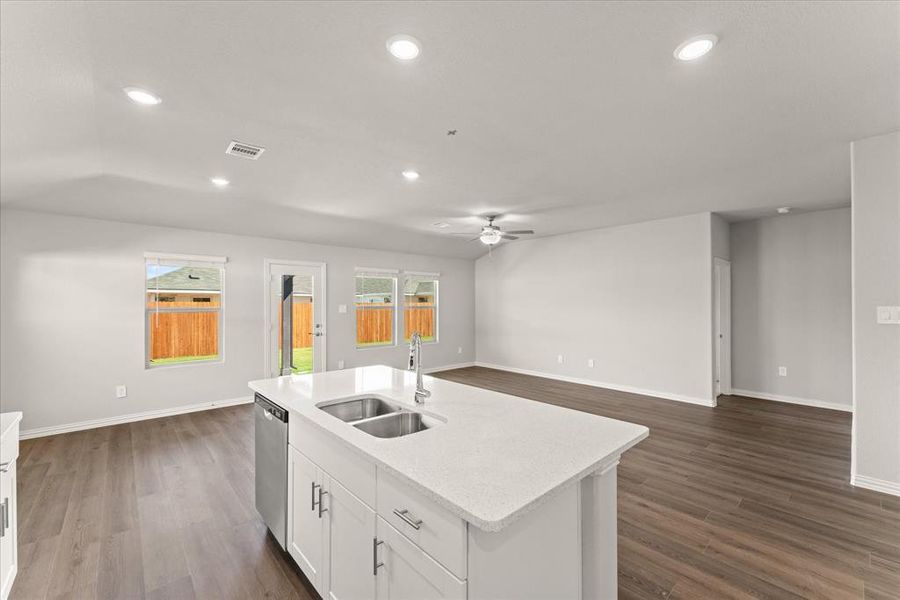 Kitchen featuring white cabinetry, ceiling fan, stainless steel dishwasher, dark hardwood / wood-style floors, and sink