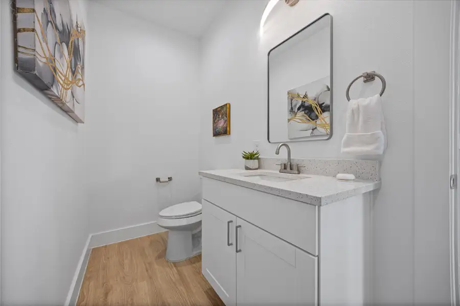 A well-lit powder room offers clean lines and durable flooring. A well-lit powder room offers clean lines and durable flooring.