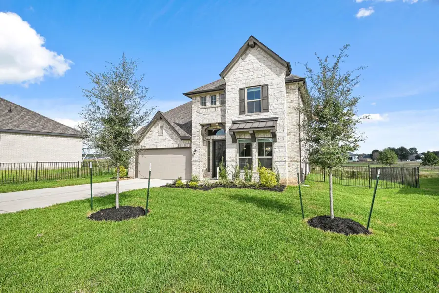 Front exterior of a new home in Waterstone on Lake Conroe, Montgomery, TX, highlighting curb appeal (Image 2). Front exterior of a new home in Waterstone on Lake Conroe, Montgomery, TX, highlighting curb appeal (Image 2).