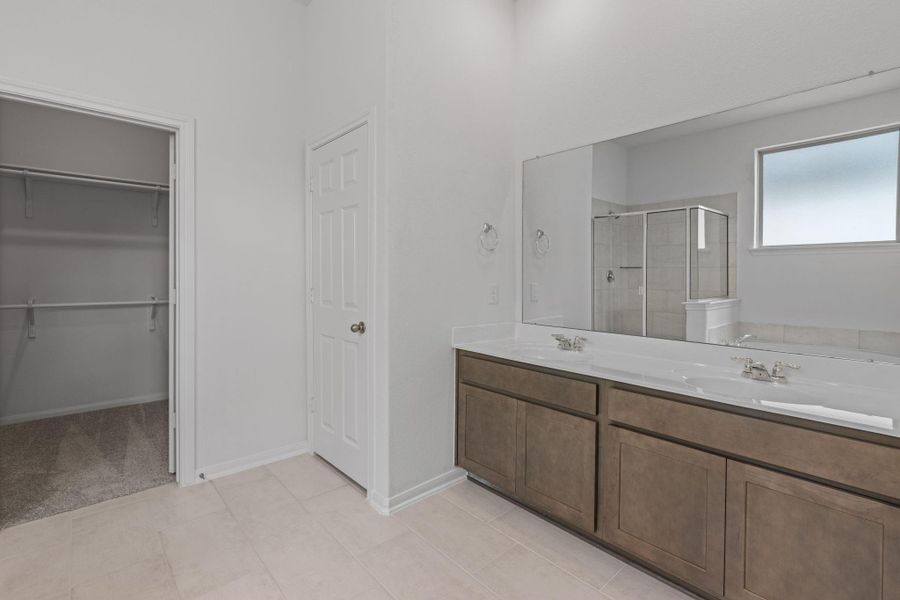 The en-suite bathroom offers a spa-like atmosphere with its elegant design, high end finishes, and tasteful lighting, creating a retreat within your own home. The en-suite bathroom offers a spa-like atmosphere with its elegant design, high end finishes, and tasteful lighting, creating a retreat within your own home.