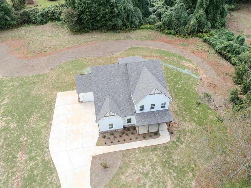 Front exterior of a new home in , Hoschton, GA, highlighting curb appeal (Image 28).