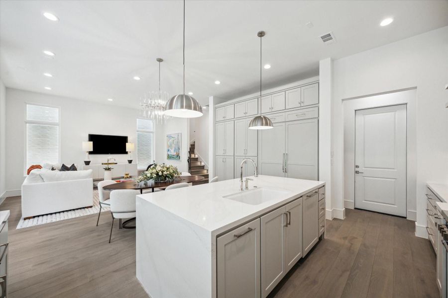 Polished Calcatta Gold Quartz waterfall island and undermount Porcelain sink with Kallista faucet complete this luxury kitchen. Ample prep space, storage space, and island seating make this space functional and stunning. Polished Calcatta Gold Quartz waterfall island and undermount Porcelain sink with Kallista faucet complete this luxury kitchen. Ample prep space, storage space, and island seating make this space functional and stunning.