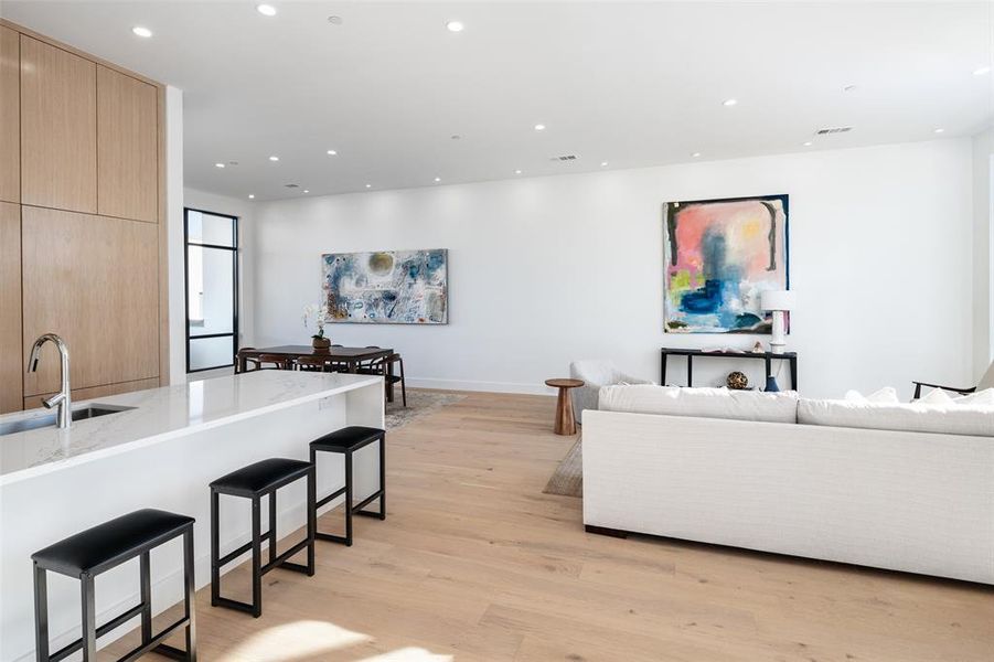 Living room featuring sink and light hardwood / wood-style floors