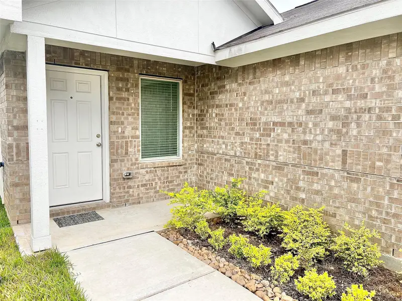 Exterior details and patio area of a home in Tavola: Cottage Collection, New Caney (Image 3).