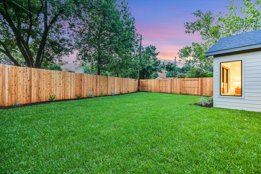 A pristine lawn stretches across the fenced backyard, providing a private oasis bordered by lovely native Texas plantings. A pristine lawn stretches across the fenced backyard, providing a private oasis bordered by lovely native Texas plantings.