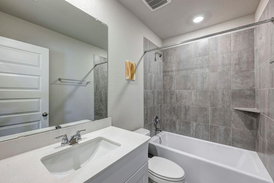 The second bathroom features a shower/tub combo and is in the front hall near the three secondary bedrooms. The second bathroom features a shower/tub combo and is in the front hall near the three secondary bedrooms.