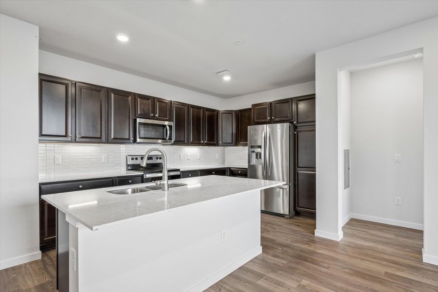 A kitchen with black cabinets.