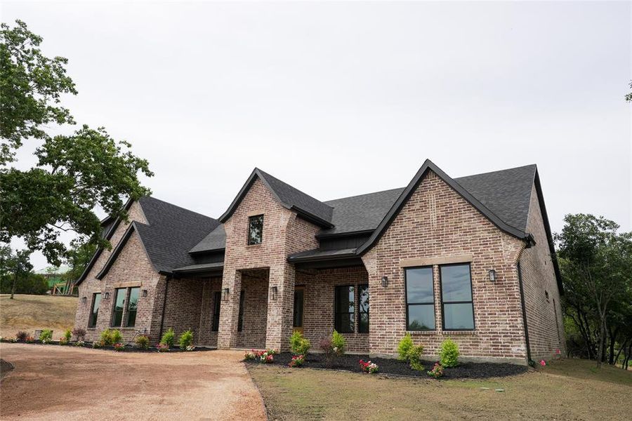Front exterior of a new home in , Weatherford, TX, highlighting curb appeal (Image 26). Front exterior of a new home in , Weatherford, TX, highlighting curb appeal (Image 26).
