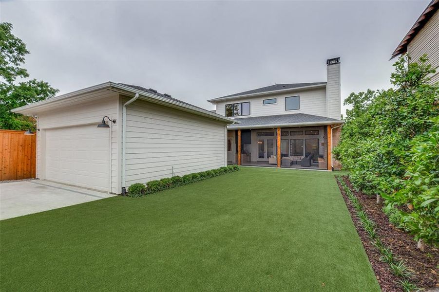 View of front of home with a chimney, driveway, fence, a sunroom, and a front lawn View of front of home with a chimney, driveway, fence, a sunroom, and a front lawn