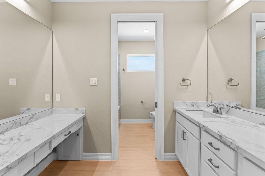 Beautifully appointed full bath shared by the secondary bedrooms, showcasing modern tile, quartz counters, and sleek fixtures.