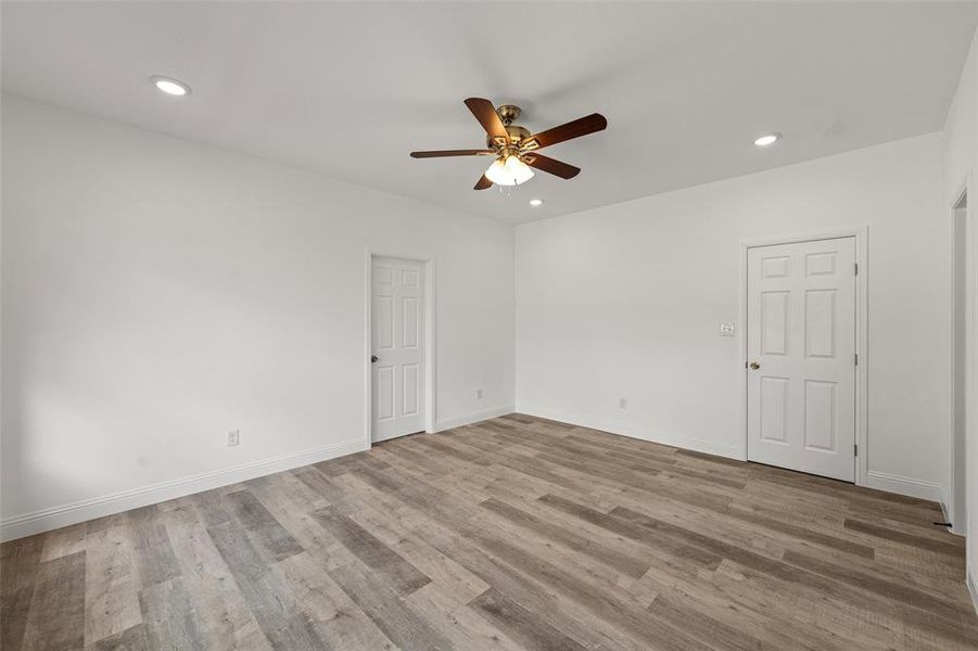 Unfurnished room with wood-type flooring and ceiling fan