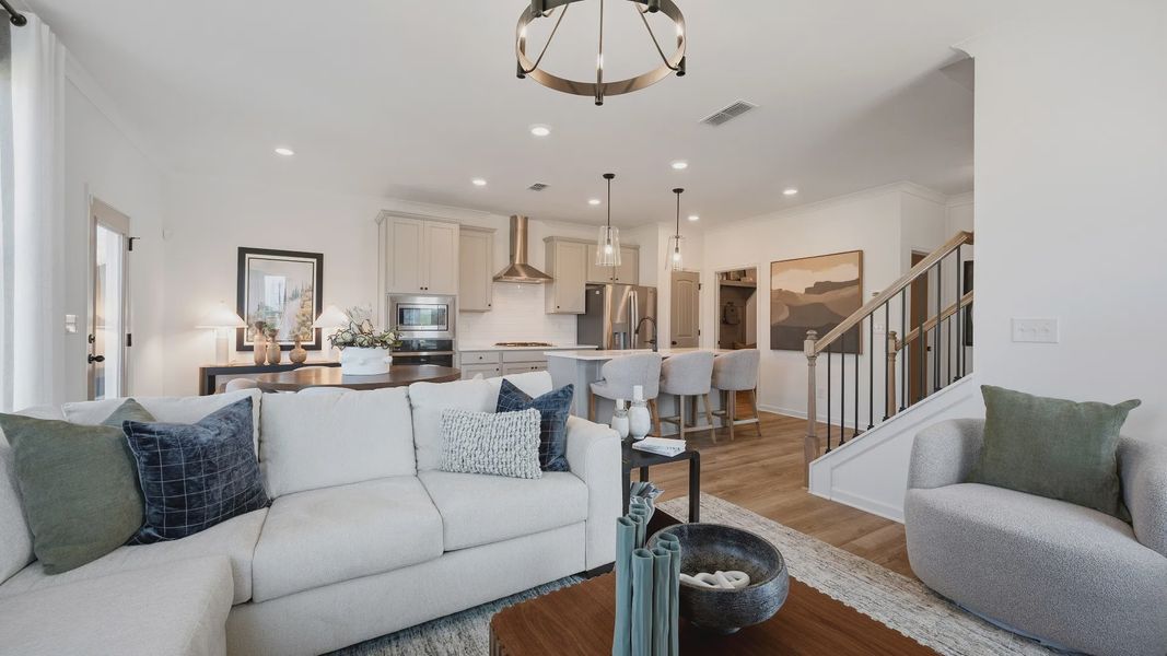Open family room with seamless flow to kitchen and abundant natural light in Langley Overlook townhome in Loganville, GA. Open family room with seamless flow to kitchen and abundant natural light in Langley Overlook townhome in Loganville, GA.