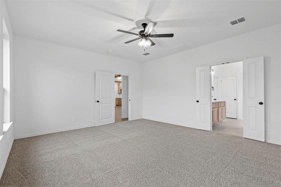 Unfurnished room featuring ceiling fan and light colored carpet