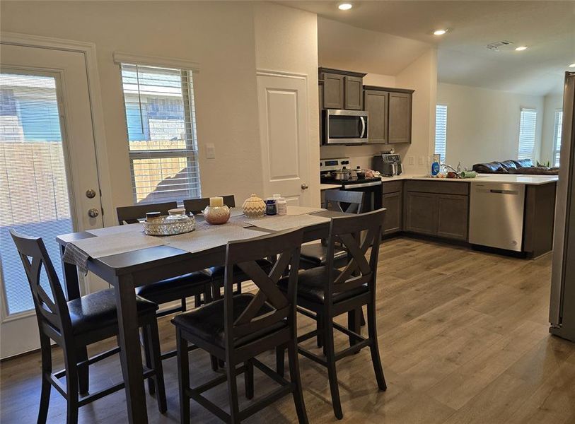 Dining room with light hardwood / wood-style flooring and sink