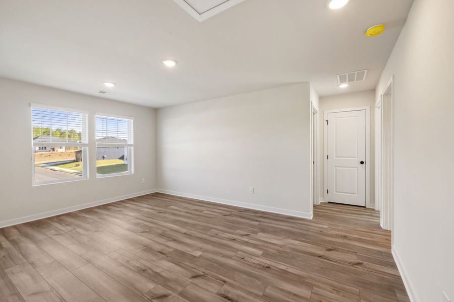 A room with a wood floor and white walls. A room with a wood floor and white walls.