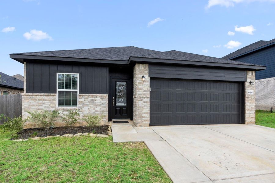 Front exterior of a new home in Glen Oaks, Magnolia, TX, highlighting curb appeal (Image 2). Front exterior of a new home in Glen Oaks, Magnolia, TX, highlighting curb appeal (Image 2).