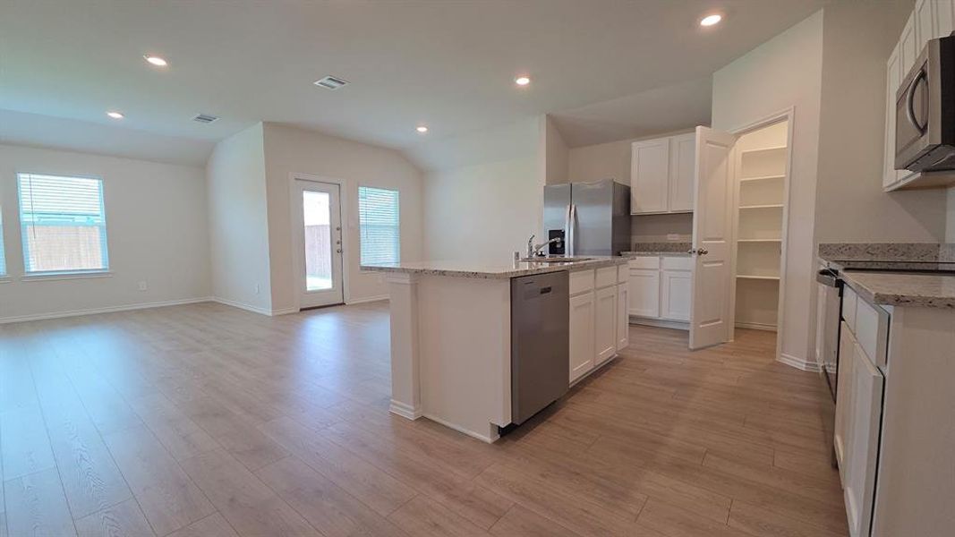 Open-concept living space featuring wood-finish flooring