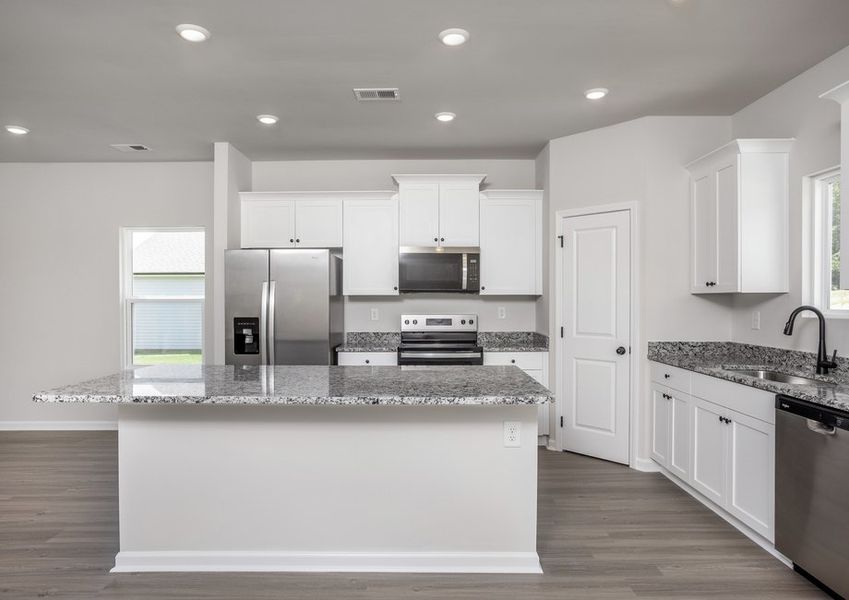 The kitchen has designer wood cabinetry