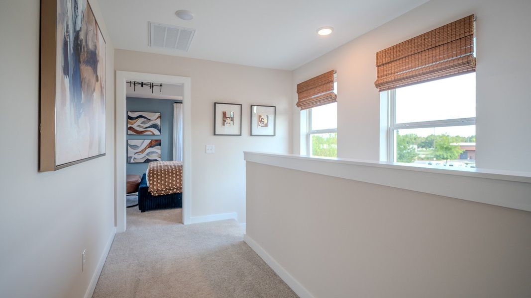 Hallway on second floor with access to secondary bedroom and stairs