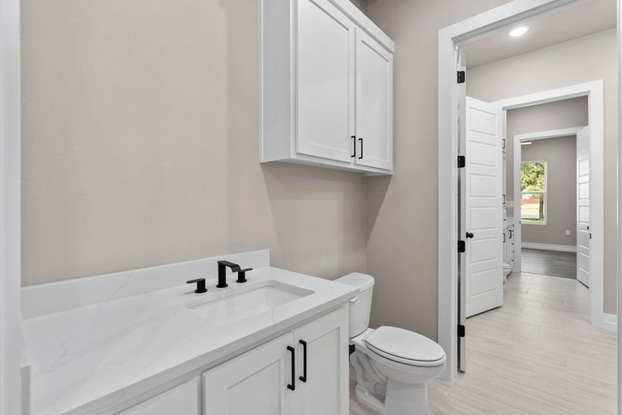 Modern white cabinetry and sleek fixtures define this pristine bathroom space. Modern white cabinetry and sleek fixtures define this pristine bathroom space.