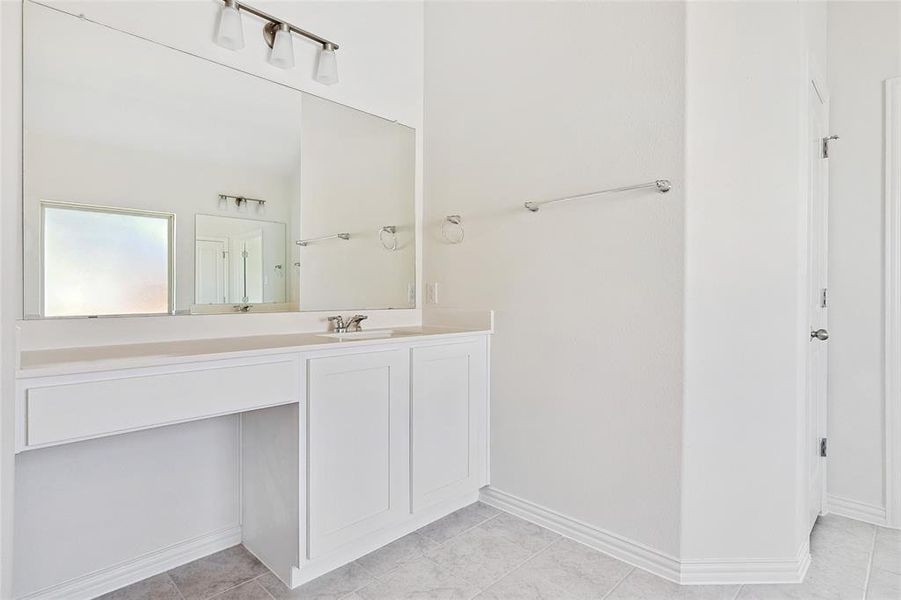 Bathroom featuring tile patterned flooring and vanity