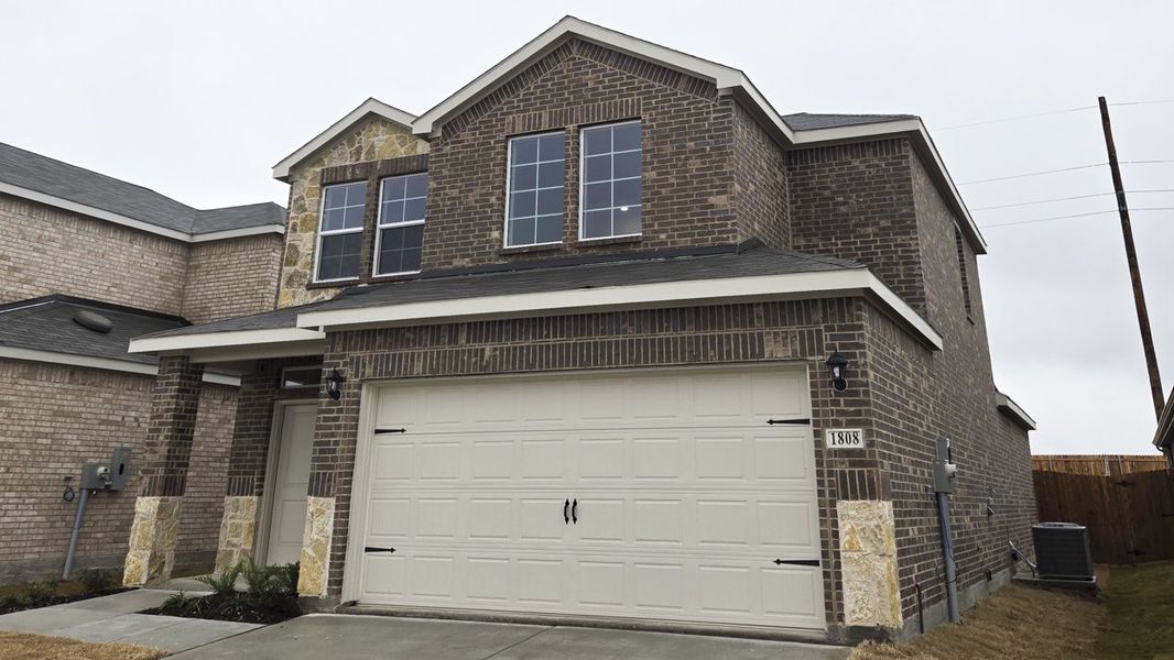 Front exterior of a new home in Creekside Ranch, Blue Ridge, TX, highlighting curb appeal (Image 1).