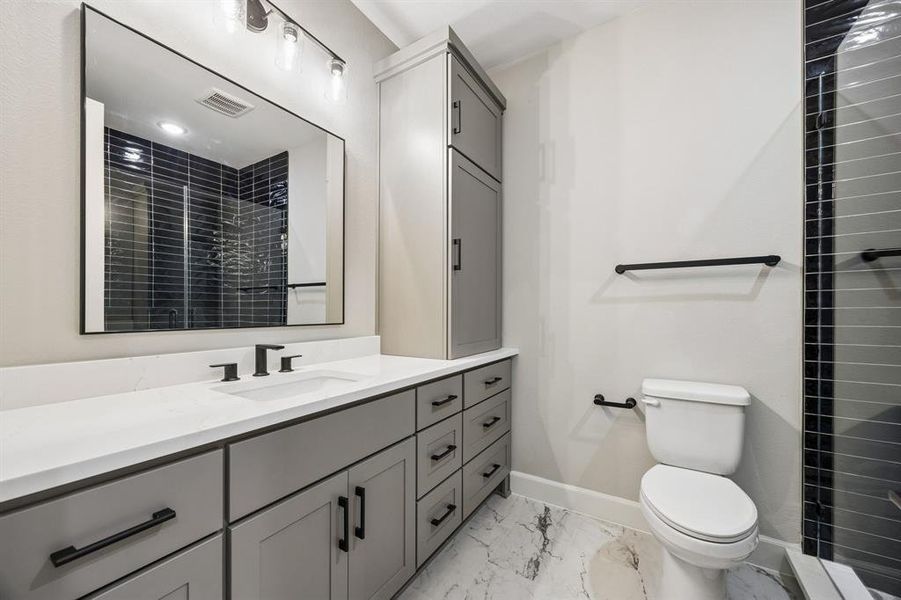 Full bathroom with vanity, a shower stall, and light marble finish flooring Full bathroom with vanity, a shower stall, and light marble finish flooring