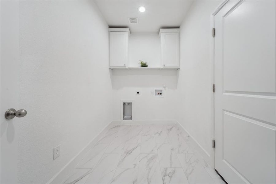 Utility room with electric dryer hookup, hookup for a washing machine, cabinets, and gas dryer hookup