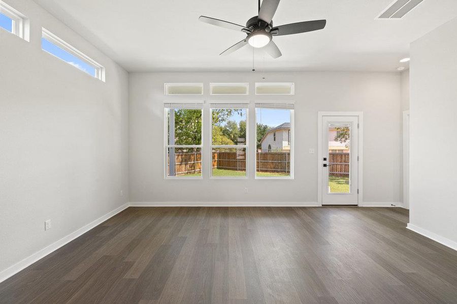 Spare room with dark wood-style flooring and ceiling fan