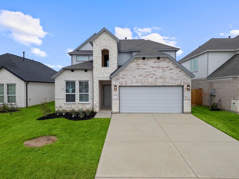 Front exterior of a new home in Barton Creek Ranch, Conroe, TX, highlighting curb appeal (Image 14).