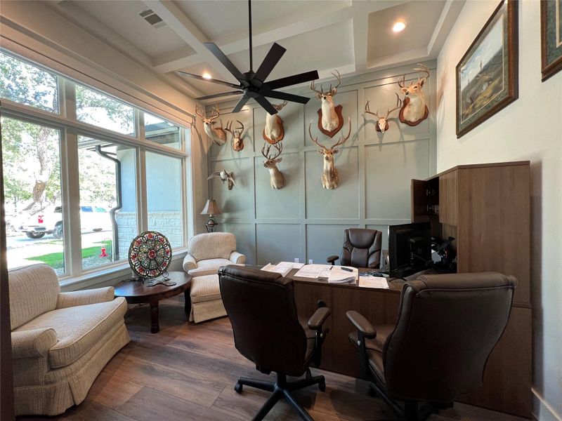 Office space with a decorative wall, , a ceiling fan, coffered ceiling, and beam ceiling Office space with a decorative wall, , a ceiling fan, coffered ceiling, and beam ceiling