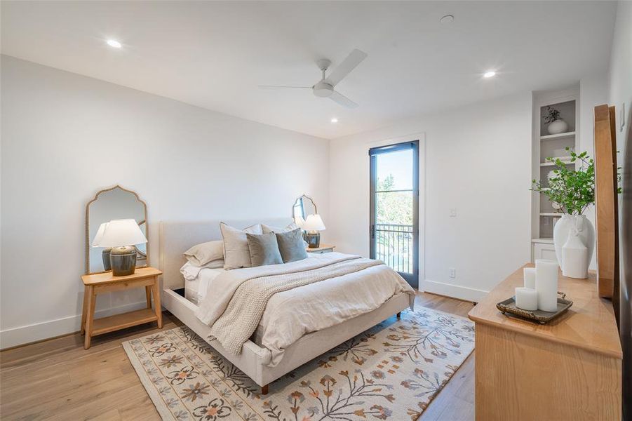 Bedroom with light hardwood / wood-style flooring, access to outside, and ceiling fan