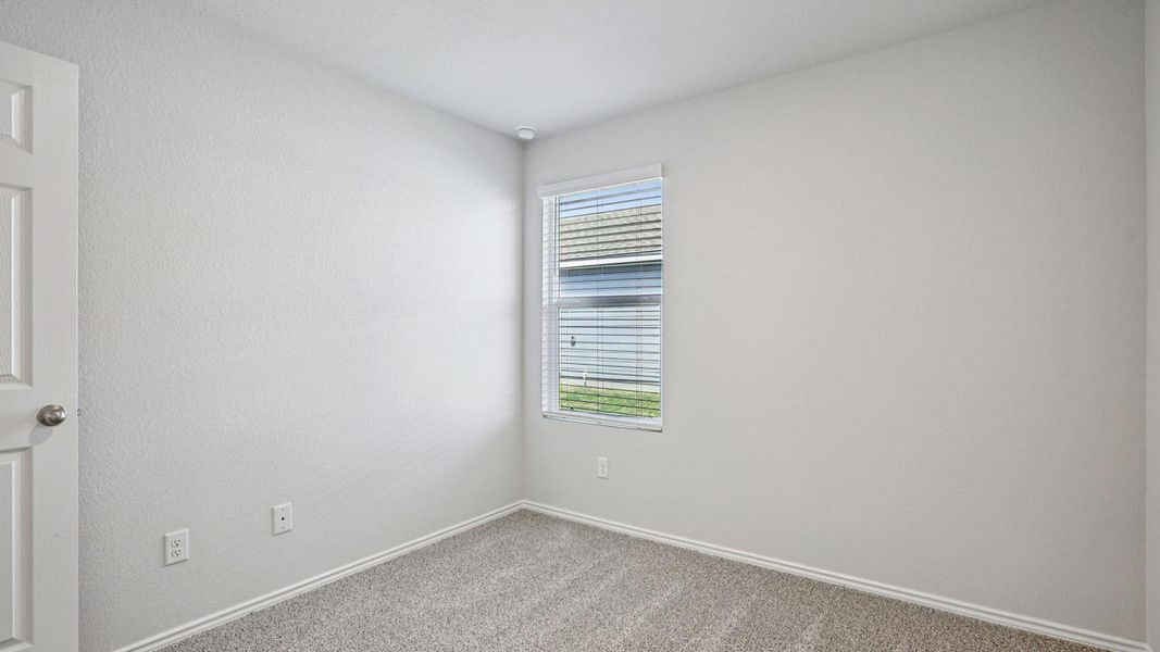 Well-lit room offers comfort and simplicity, perfect for relaxation.