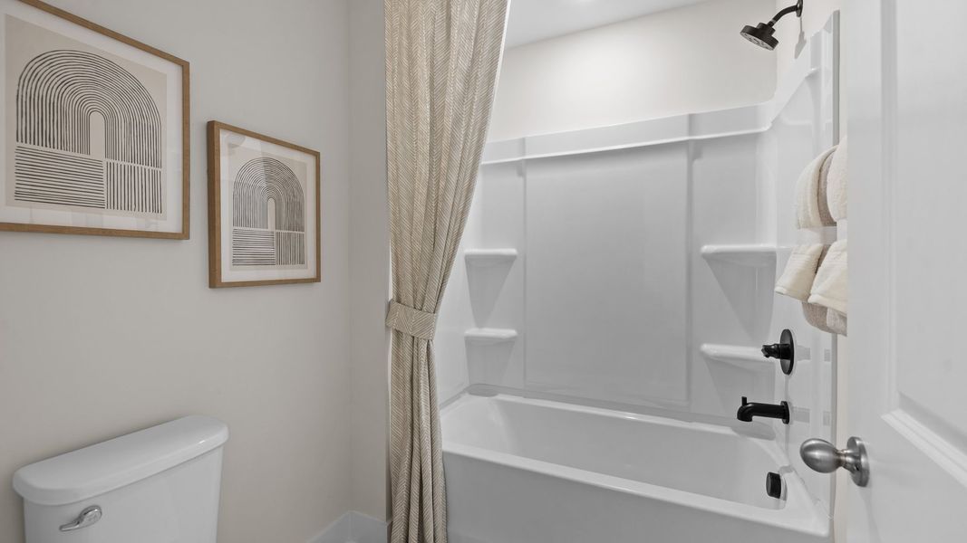 Large soak-in tub in the secondary bathroom in the Jordan Design by DRB Homes in York, SC