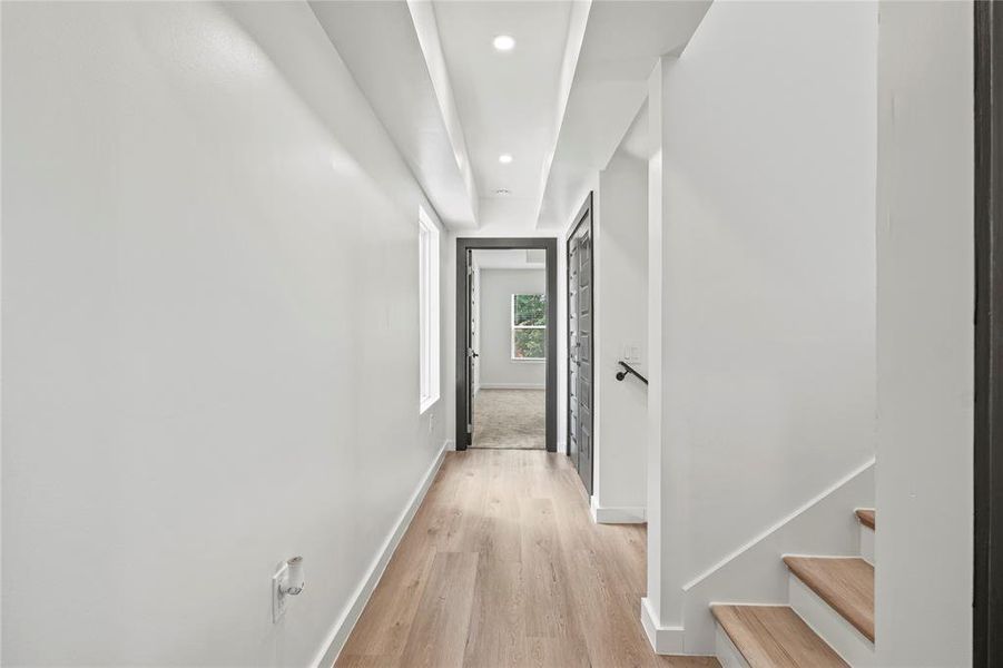 Hall featuring light wood-style flooring and recessed lighting Hall featuring light wood-style flooring and recessed lighting