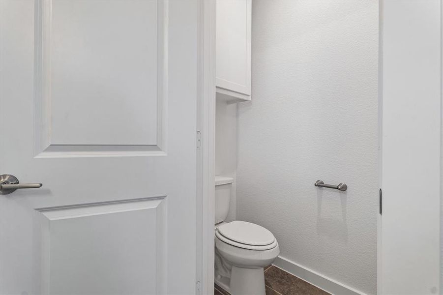 Bathroom with tile patterned floors and toilet