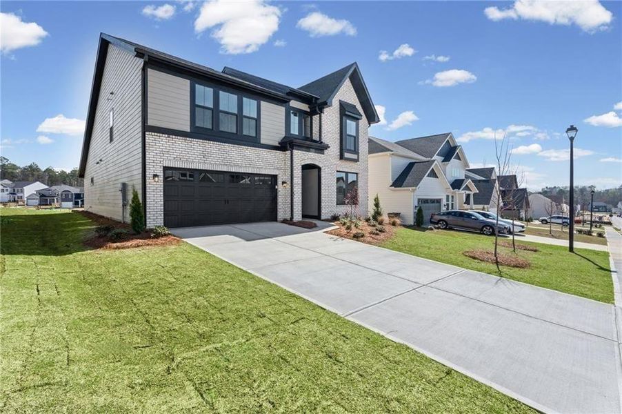 Front exterior of a new home in Twin Lakes, Hoschton, GA, highlighting curb appeal (Image 25). Front exterior of a new home in Twin Lakes, Hoschton, GA, highlighting curb appeal (Image 25).