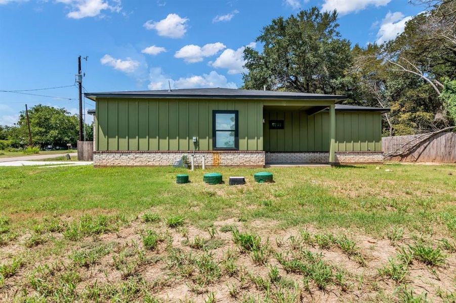 Back of house with board and batten siding Back of house with board and batten siding