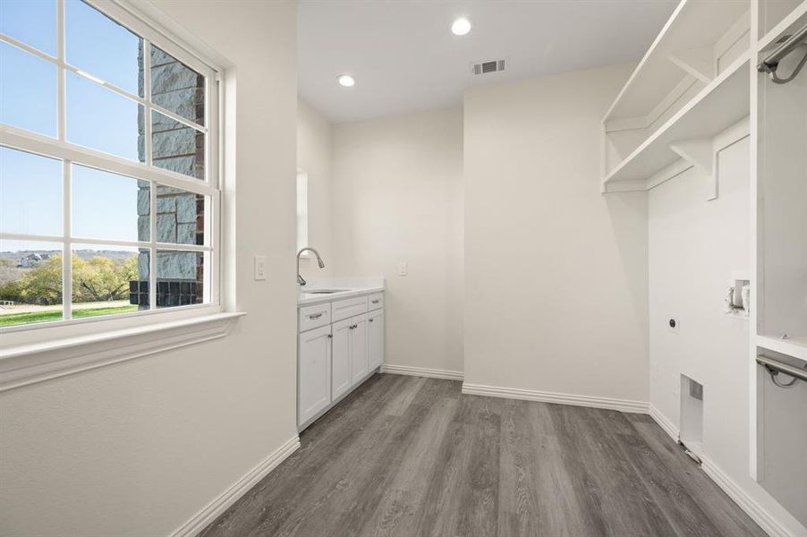Washroom featuring electric dryer hookup, dark wood finished floors, and recessed lighting Washroom featuring electric dryer hookup, dark wood finished floors, and recessed lighting