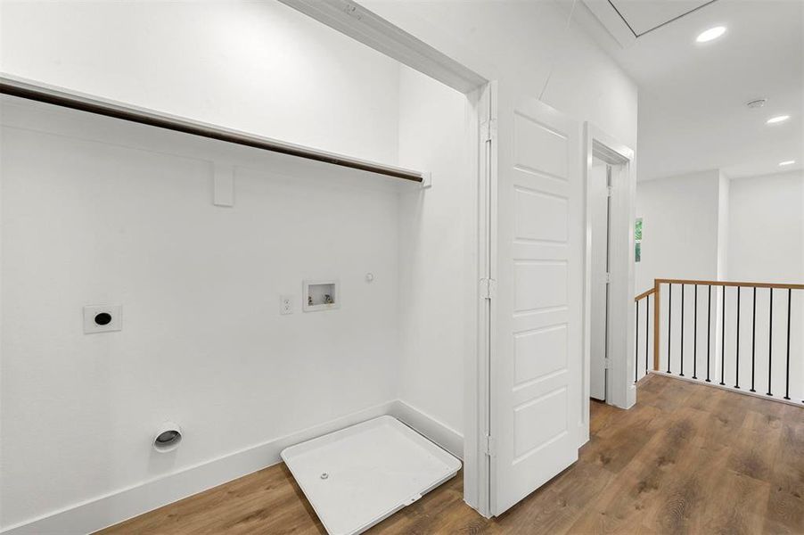 Laundry room with gas dryer hookup, electric dryer hookup, hardwood / wood-style floors, and washer hookup