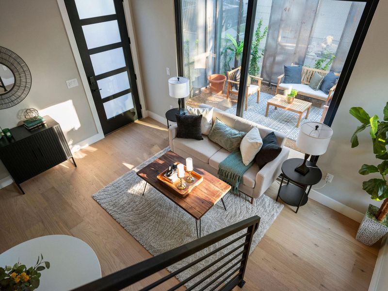 Living area with baseboards and wood finished floors