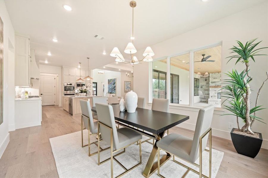 Dining space featuring light hardwood / wood-style flooring and a chandelier