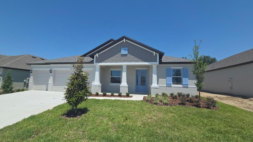Representative exterior photo of a completed home built from the Joyce by William Ryan Homes in Pinecone Reserve, Brooksville, FL (Image 26).