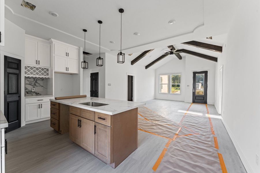 Spacious kitchen featuring abundant cabinetry, center island, and plenty of counter space for meal prep and gatherings. Photos are representative of the same floor plan built by this builder. Finishes will be the same or similar.