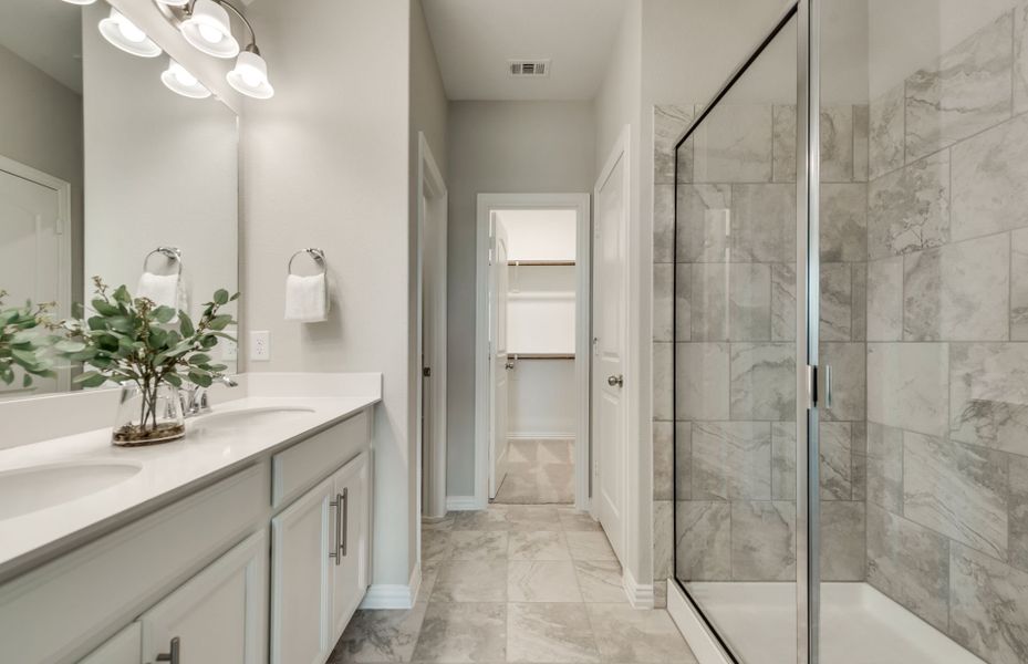 Owner's private bath with tile-surround shower and double vanity