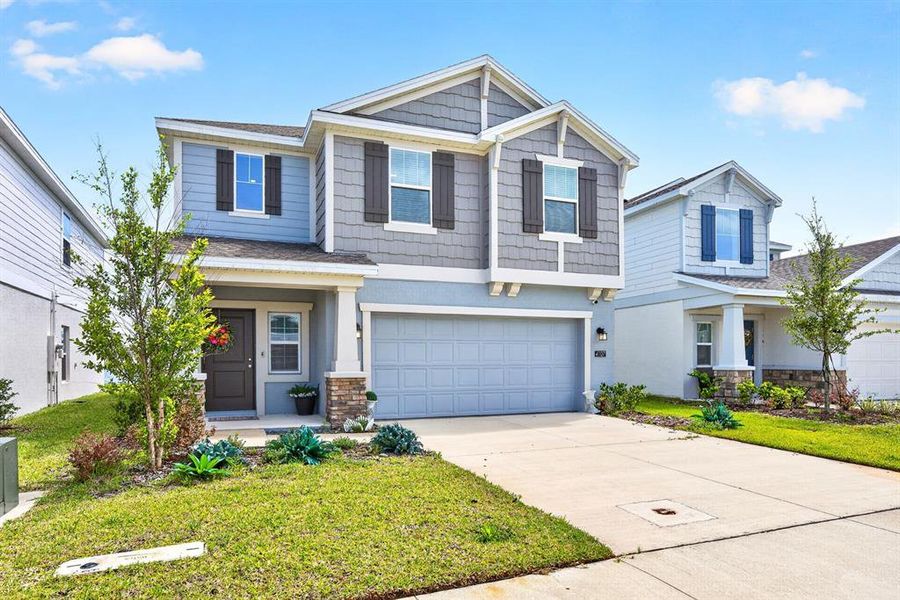 Front exterior of a new home in Preserve at LPGA, Daytona Beach, FL, highlighting curb appeal (Image 2). Front exterior of a new home in Preserve at LPGA, Daytona Beach, FL, highlighting curb appeal (Image 2).