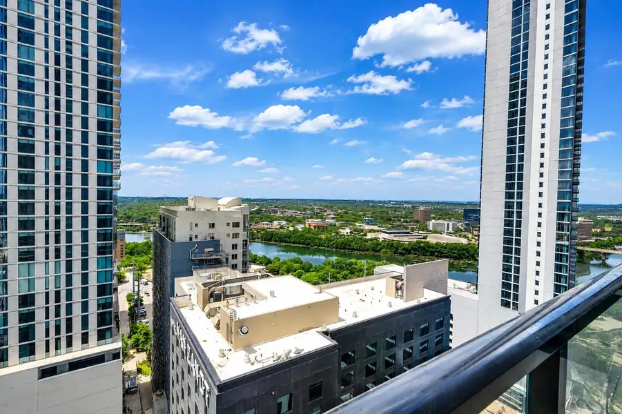 Dramatic high-rise perspectives frame a scenic river and city skyline panorama. Dramatic high-rise perspectives frame a scenic river and city skyline panorama.